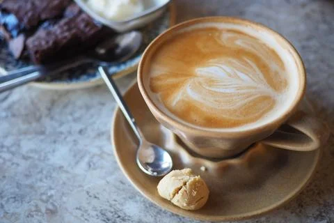 Coffee with dessert on a table at a cafe Stock Photos