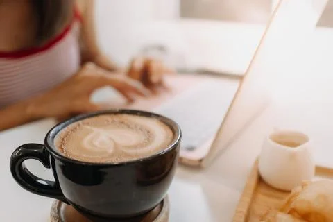 Coffee desserts and woman using laptop. Concept of relax work. Stock-Fotos