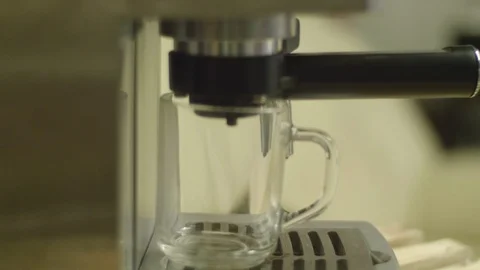 Coffee dispenser with cup of coffee. Making cappuccino in glass transparent Stock Footage 86581434