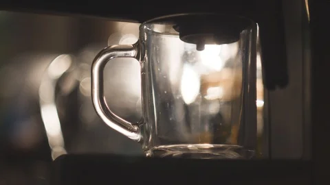 Coffee dispenser with cup of coffee. Making cappuccino in glass transparent Stock Footage 86771538