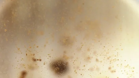 The coffee dissolves in water. Macro 4k video Stockbeeldmateriaal 69964601