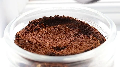 Coffee dosage from a jar with a small spoon Stock Footage 74864571