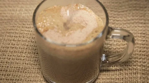 Coffee drink filled with boiling water in a glass cup on sacking Vidéo 71926326