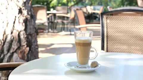 Coffee drink latte or flat white, in a transparent glass with cookie or biscuit  Stock Footage 162388926
