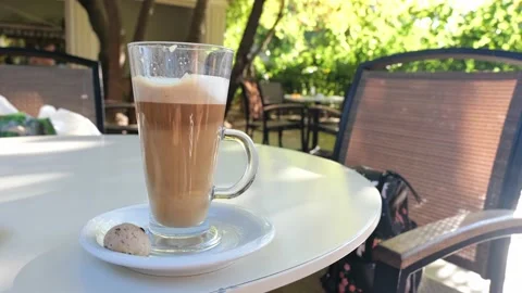 Coffee drink latte or flat white, in a transparent glass with cookie or biscuit  Stock Footage 162388979