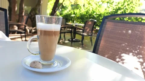 Coffee drink latte or flat white, in a transparent glass with cookie or biscuit  Stock Footage 162390052