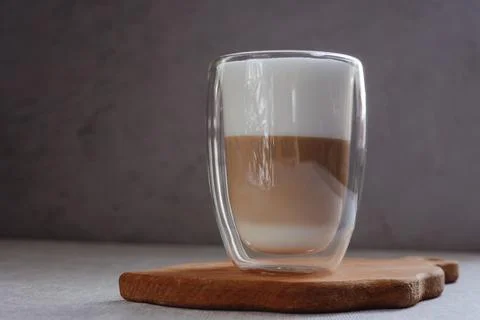 Coffee drink on a wooden board on a solid background. Stock Photos