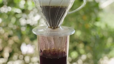 Coffee Drip Concept. Hot Water Drops from a Dripper to a Glass. Making Hot Co Stock Footage 130953086