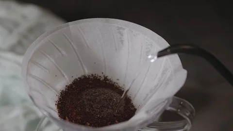 Coffee Drip Concept. Pouring Hot Water from Kettle into a Drpper. Blooming Pr Stock Footage 130048233