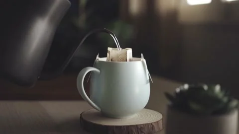 Coffee Drip at Home Concept. Pouring Hot Water from Kettle into a Dripper Bag 库存影片 134388463
