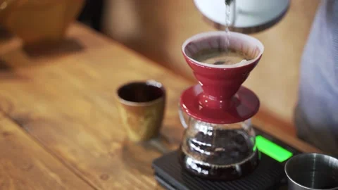 Coffee drip process by pouring hot water from kettle though ground berries bean Stock-Footage 133124877