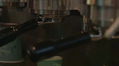 Coffee dripping from an espresso machine into a cup Stock Footage 41316196