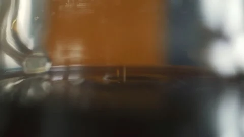 Coffee dripping from the filter drops into a glass decanter in the kitchen home Stock Footage 171154530