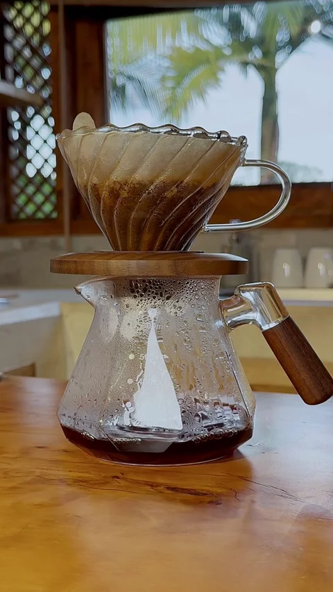 Coffee dripping through filter into glass carafe at home 스톡 동영상 331774181