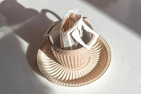Coffee Drips in cup. Alternative brewing specialty coffee in paper filter bags. Stock Photos
