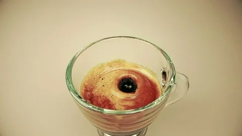 Coffee drop falling in slow motion inside of trasparent cup of espresso italian Stock Footage 91056394
