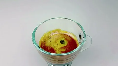 Coffee drop falling in slow motion inside of trasparent cup of espresso Stock Footage 92746776