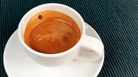 Coffee drop falling in super slow motion inside of cup of espresso italian co Stock Footage 122179527