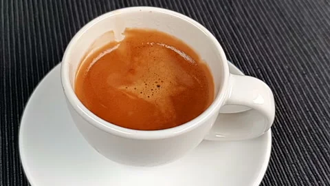 Coffee drop falling in super slow motion inside of cup of espresso italian Stock Footage 169577208