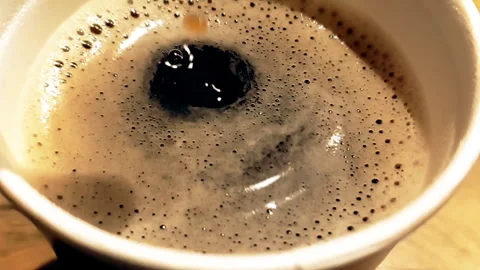 Coffee drop falling in super slow motion inside of cup of espresso italian Stock Footage 263904321