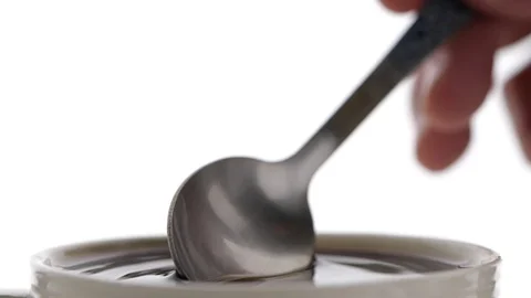 Coffee droped from spoon into the filled Cup in slow motion, Video stock 126953181
