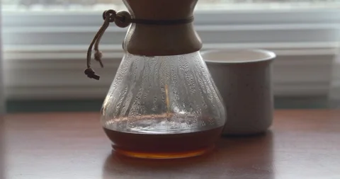 Coffee Droplets Causing Ripples in a Steamy Chemex Stock Footage 100094074