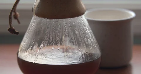 Coffee Droplets Causing Ripples in a Steamy Chemex Stock Footage 100094740