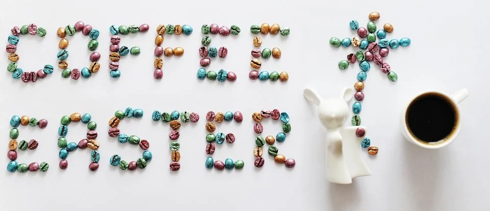 Coffee Easter. Lettering made of multi-colored pearl coffee beans on white Stock Photos
