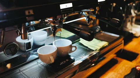 Coffee is filled into cups from a coffee machine Stock Footage 124148613
