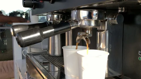Coffee filtering through a coffee barista machine into take away cups. Stock Footage 101614323