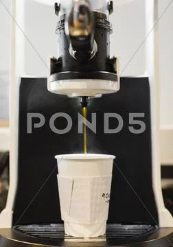 Coffee Flowing From Coffee Machine In Coffee Shop