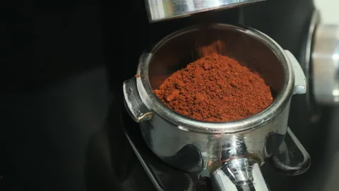 Coffee flows in thin dark stream into metal portafilter Video stock 306583067