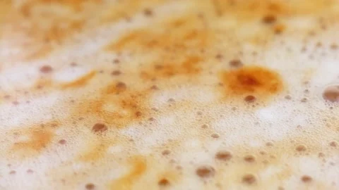 Coffee foam close-up. Stirring coffee drink. Macro video of coffee bubbles Stock Footage 220085366