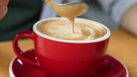 Coffee foam drips from spoon. Video stock 273023372
