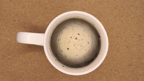 Coffee foam rotating in the white cup close up Stock Footage 171828141