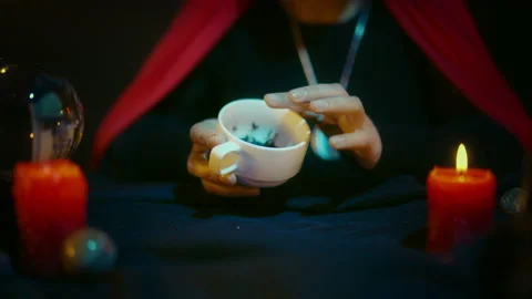 Coffee fortune teller looking at grounds pattern and interpreting it to client Video stock 197990127