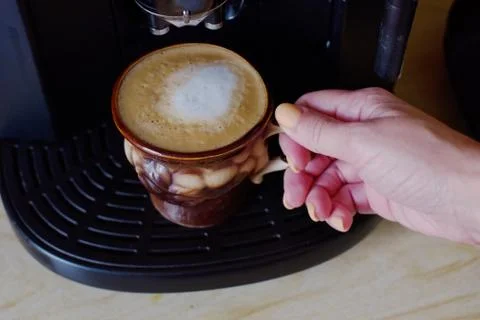 Coffee. Freshly made Flat White. Cappuccino coffee drink in a brown cup Stock Photos