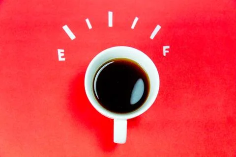 Coffee is a fuel concept - a cup on a red background Stock Photos