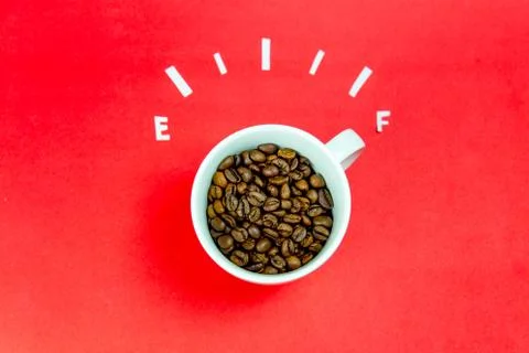 Coffee is a fuel concept - a cup on a red background Stock Photos