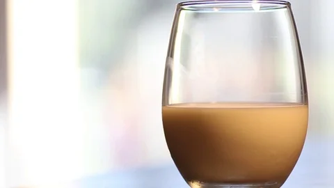 Coffee gets poured into a glass of milk. Stock Footage