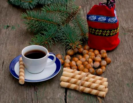 Coffee, gift bag, forest nutlets, linking of cookies and fir-tree branch Stock Photos