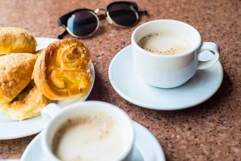 Coffee with glasses on the table. Delicious baking with a coffee. Stock Photos
