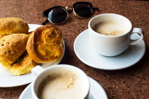Coffee with glasses on the table. Delicious baking with a coffee. Stock Photos