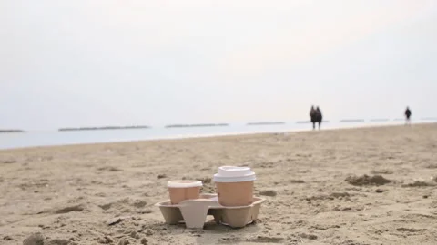 Coffee to go. Coffee break in an open space. Morning coffee on the seashore by Video stock 186002978