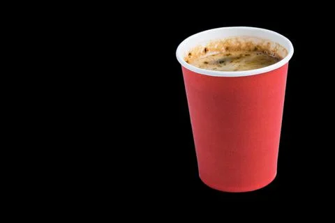 Coffee to go in a paper cup without a lid on a black background copy space to Stock Photos