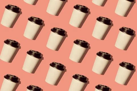 Coffee to go regular pattern made of photo on a coral pink color background.  Stock Photos