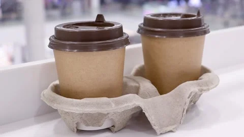 Coffee to go. Two takeaway coffees on the table. Stock Footage 233023805
