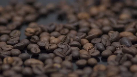 Coffee grains close-up on a dark table. Macro Stock Footage 145792905