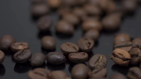 Coffee grains close-up on a dark table. Macro Stock Footage 145792942