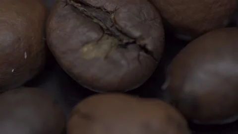 Coffee grains close-up on a dark table. Macro Stock Footage 145792949